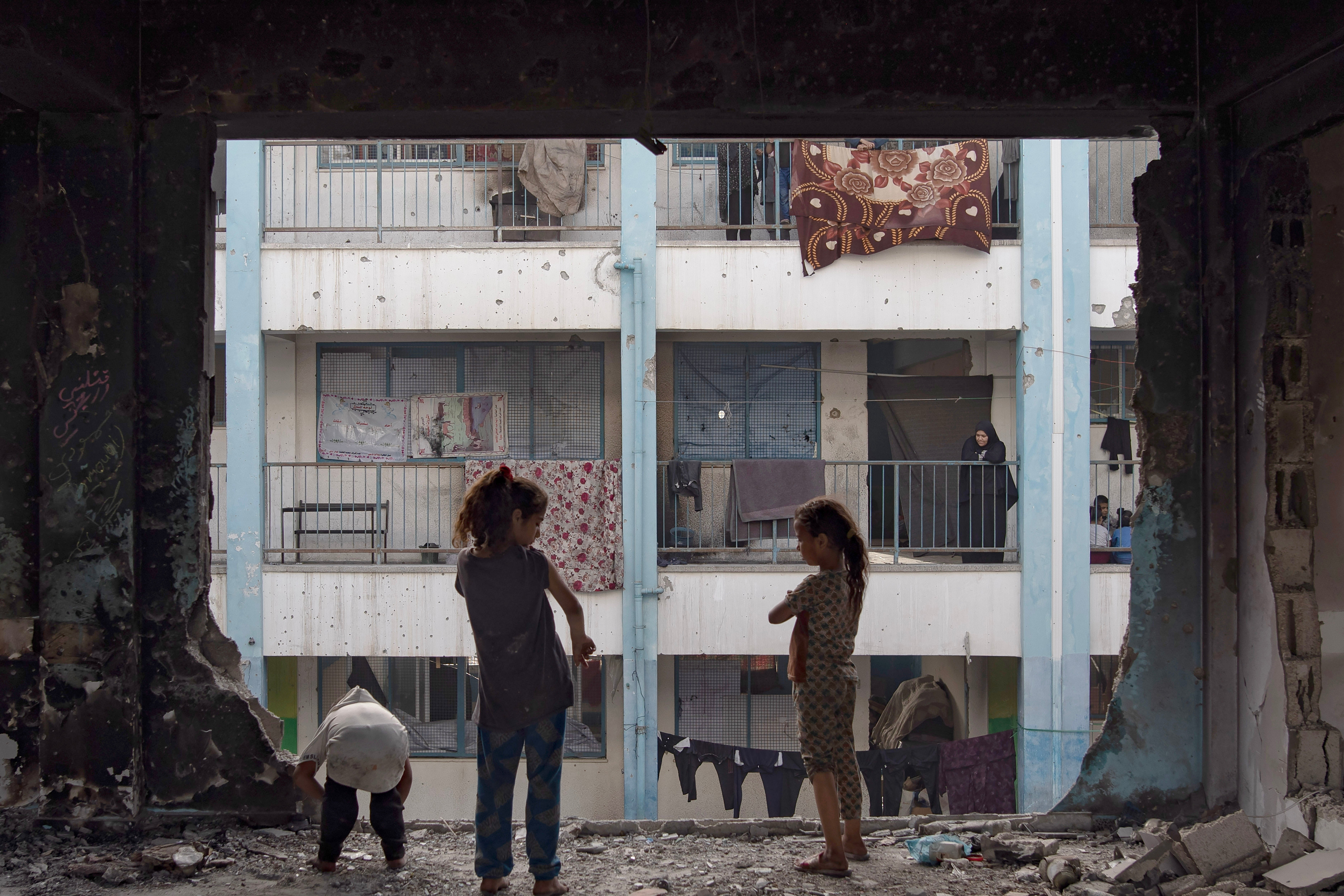 Displaced Palestinians reside in a damaged UNRWA school after the Israeli army inquired to leave the city of Rafah, in the Khan Yunis