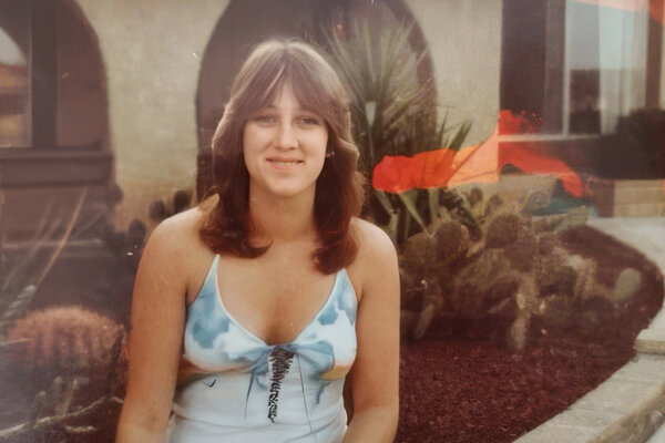 A portrait of Cathy Small, standing in front of a home.